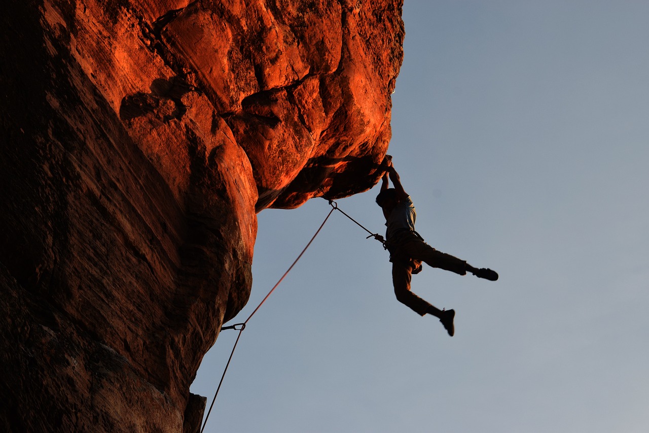 Foto de un escalador subiendo una vía de escalada deportiva